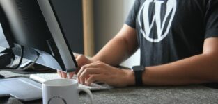 Person In Black And White T-shirt Using Computer